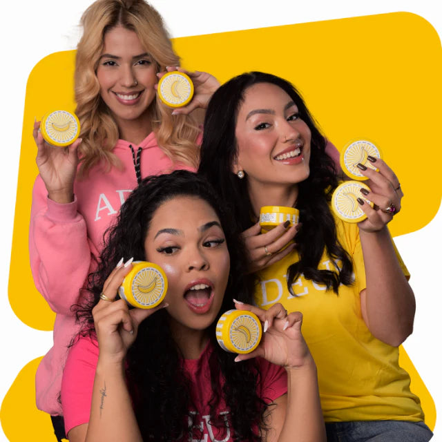 ADEUS Banana Glow Duo with dark spot corrector cream and radiance renewal scrub, shown with models holding the skincare kit.