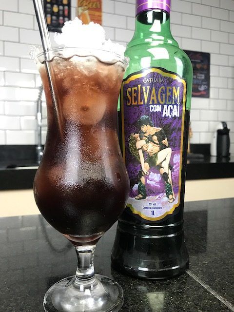 Bottle of COMARY Selvagem cocktail featuring a colorful label with images of açaí, catuaba, guaraná, and marapuama herbs.