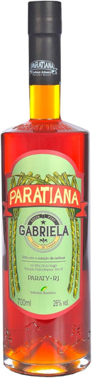 Gabriela Paratiana Cachaça Liqueur bottle, 700ml, with a clear glass bottle and colorful label, on a wooden surface