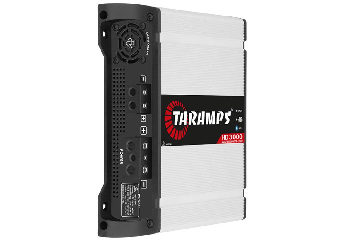 Taramps HD3000 car audio amplifier showing black metal casing and control knobs for 3000 Watts RMS power output.